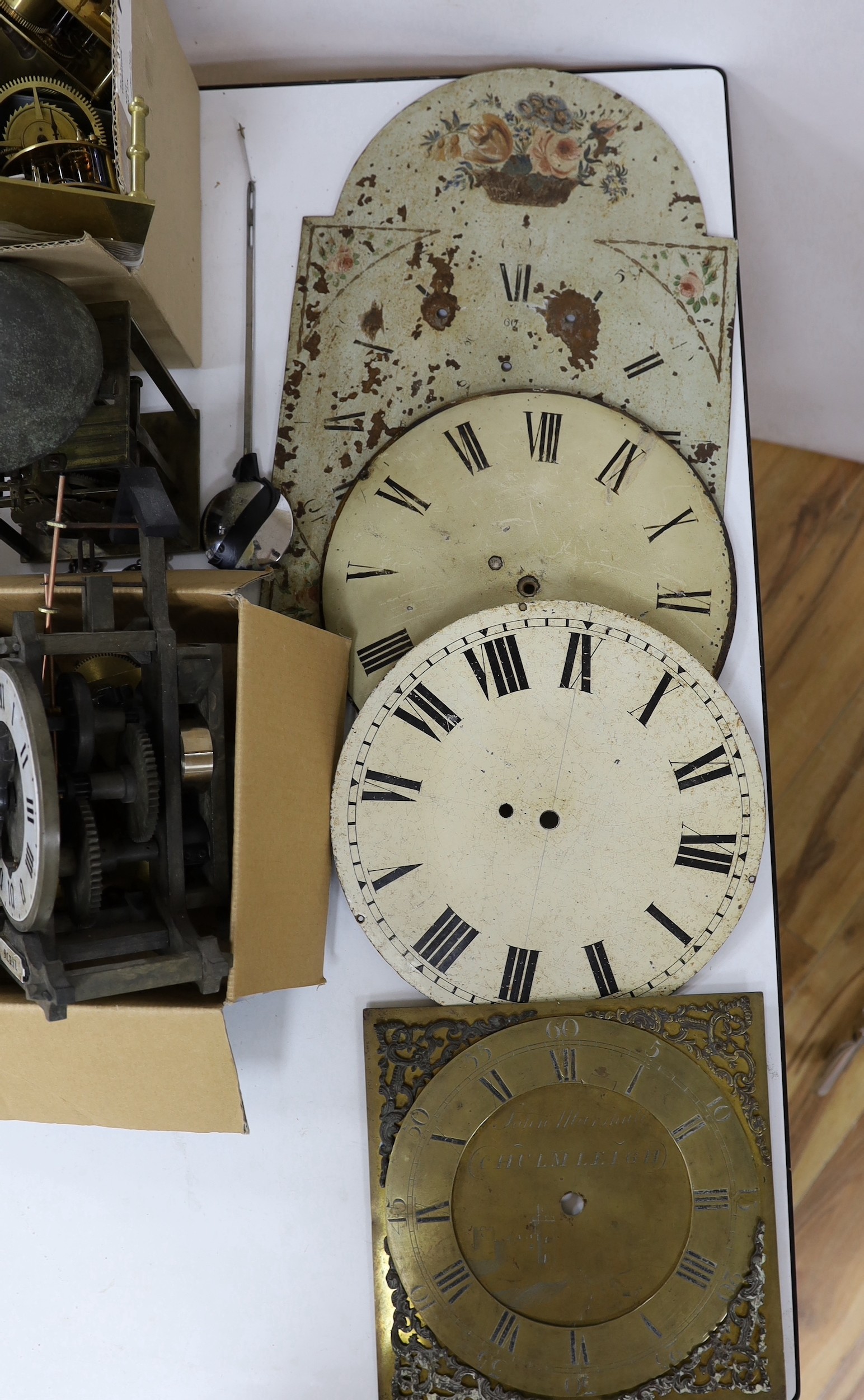 A large quantity of clock parts, to include movements, dials etc., including a John Marshall of Chulmleigh clock face